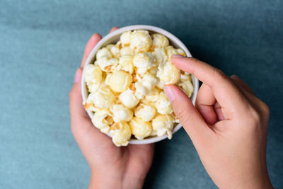 Cropped hand holding popcorn