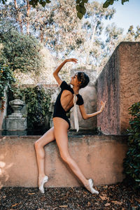 Young professional ballerina posing outdoors