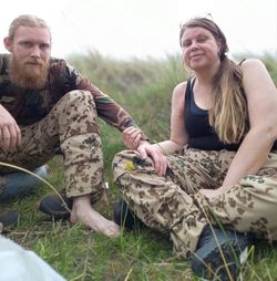 Happy friends sitting on grass