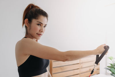 Smiling woman exercising at home