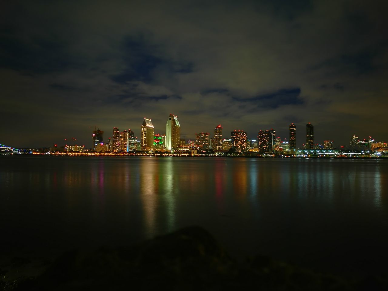 ILLUMINATED CITY AT WATERFRONT