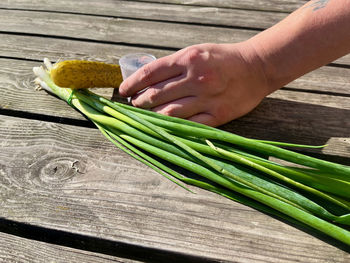 Cropped hand of man cutting board