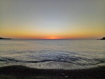 Scenic view of sea against clear sky during sunset