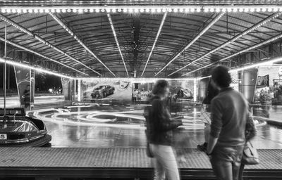 People standing in illuminated underground walkway