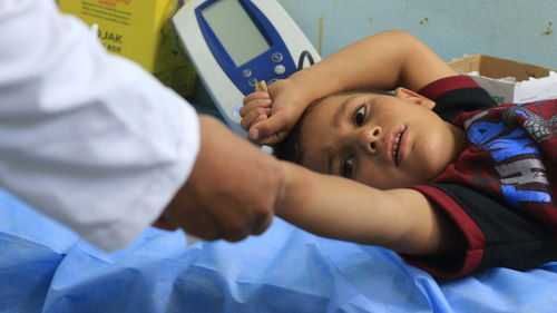 Doctor examining boy at clinic