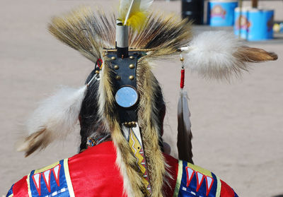 Rear view of person in traditional clothing and headdress