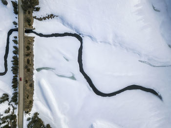 High angle view of river amidst snow covered land