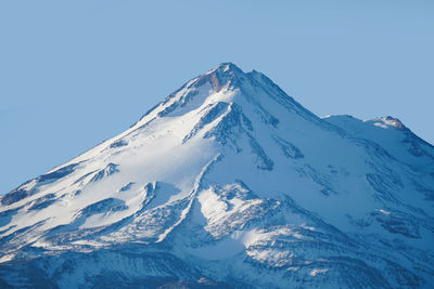 Scenic view of snowcapped mountains against clear sky