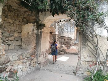 Rear view of woman standing on rock