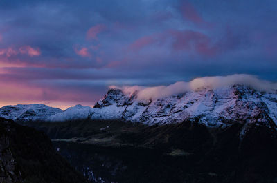 Scenic view of snowcapped mountains against sky during sunset