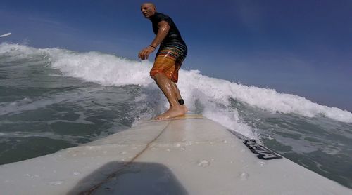 People surfing in sea