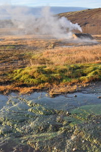 Scenic view of sea and mountains against sky