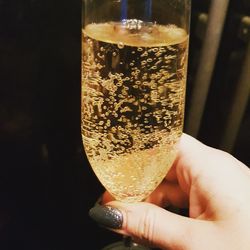 Close-up of hand holding beer glass