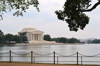 Jefferson memorial by lake against sky