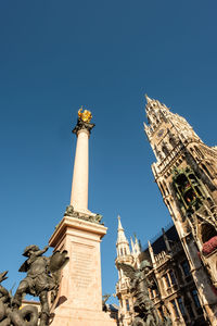 Low angle view of statue of building against clear sky