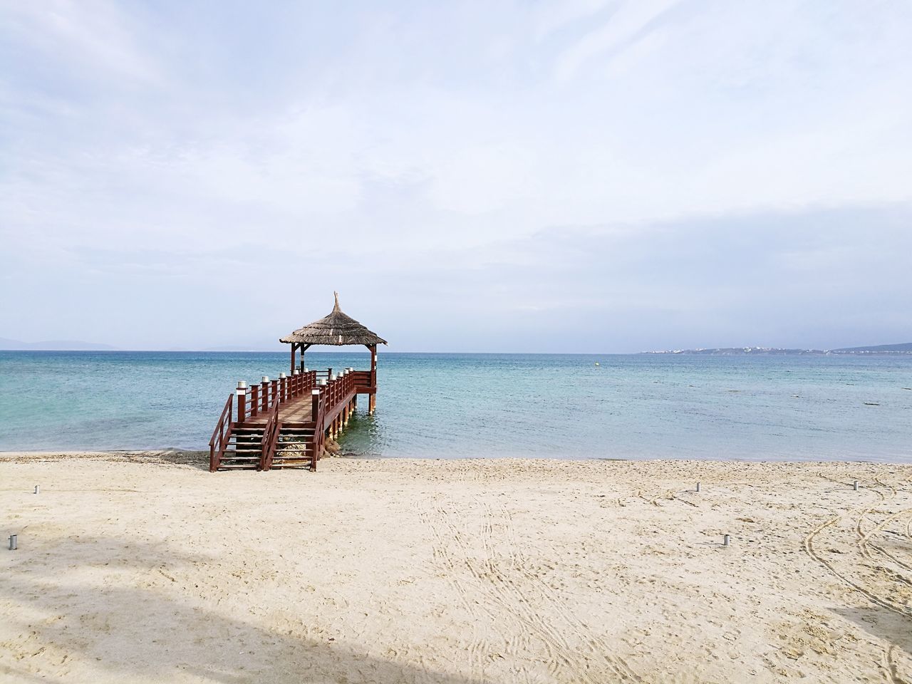 beach, sea, water, sand, sky, horizon over water, shore, nature, outdoors, cloud - sky, day, tranquility, built structure, scenics, no people, beauty in nature, vacations