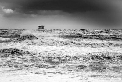 Scenic view of oil platform in the sea against sky