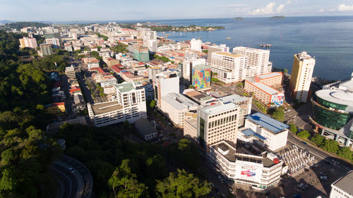 High angle view of buildings and sea in city