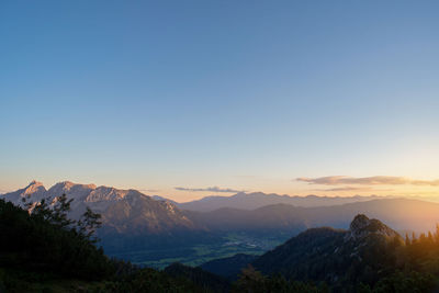 Scenic landscape view of mountains against clear sky during sunset