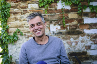 Portrait of smiling man standing outdoors