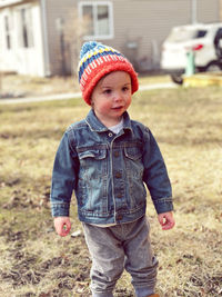 Portrait of cute boy standing on field