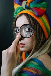 Close-up portrait of woman with colorful face