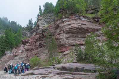 Group of people walking on rocky mountain