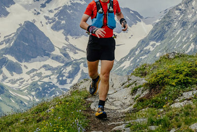 Rear view of woman standing on mountain