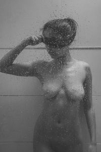 Woman standing on wet glass