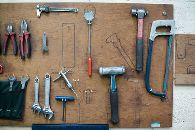 Work tools hanging on wood against wall