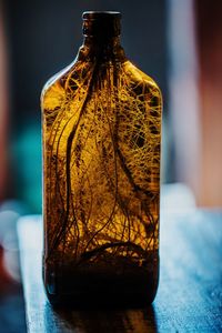 Close-up of yellow glass on table