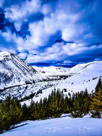 Scenic view of snowcapped mountains against sky during winter