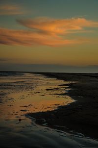 Scenic view of beach against sky during sunset