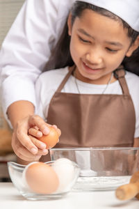 Close-up of girl with ice cream on table