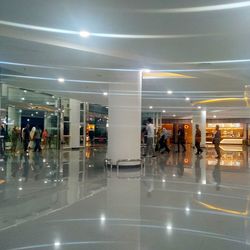 Group of people walking in illuminated building