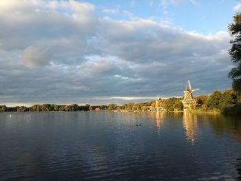 View of calm lake against cloudy sky