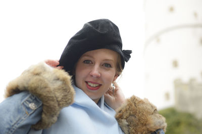 Portrait of smiling young woman in park during winter