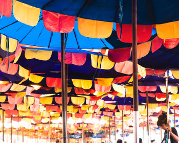 Multi colored umbrellas hanging at market stall