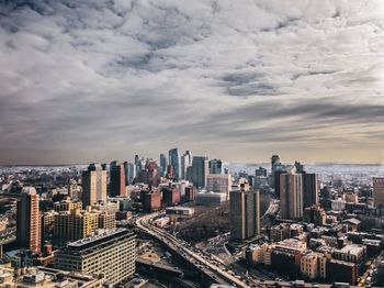 High angle view of modern buildings in city against sky