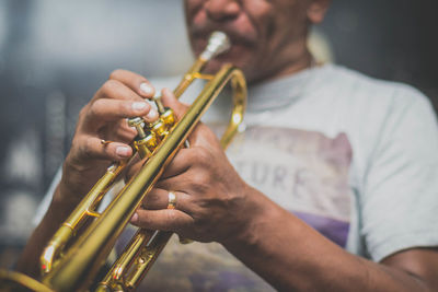 Midsection of musician playing trumpet