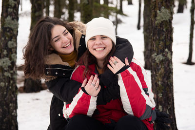 Smiling young women hugging 