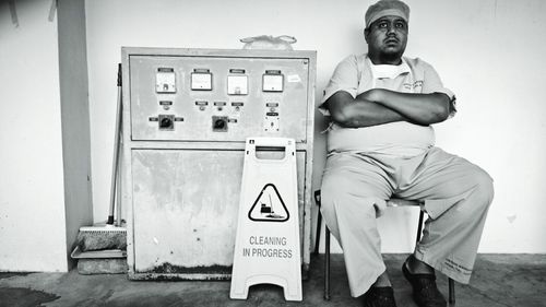 Worker sitting by machinery