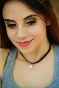Close-up of smiling woman wearing make-up