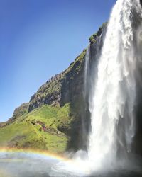 Low angle view of waterfall against sky