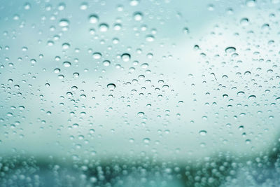 Full frame shot of wet glass window during rainy season