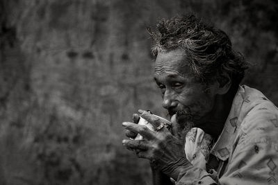 Close-up of thoughtful senior man having drink