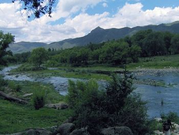 Scenic view of mountains against cloudy sky