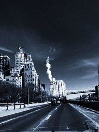 City street against cloudy sky