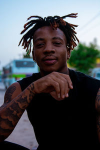 Portrait of young man standing outdoors