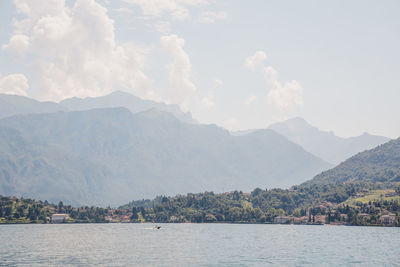 Scenic view of sea and mountains against sky